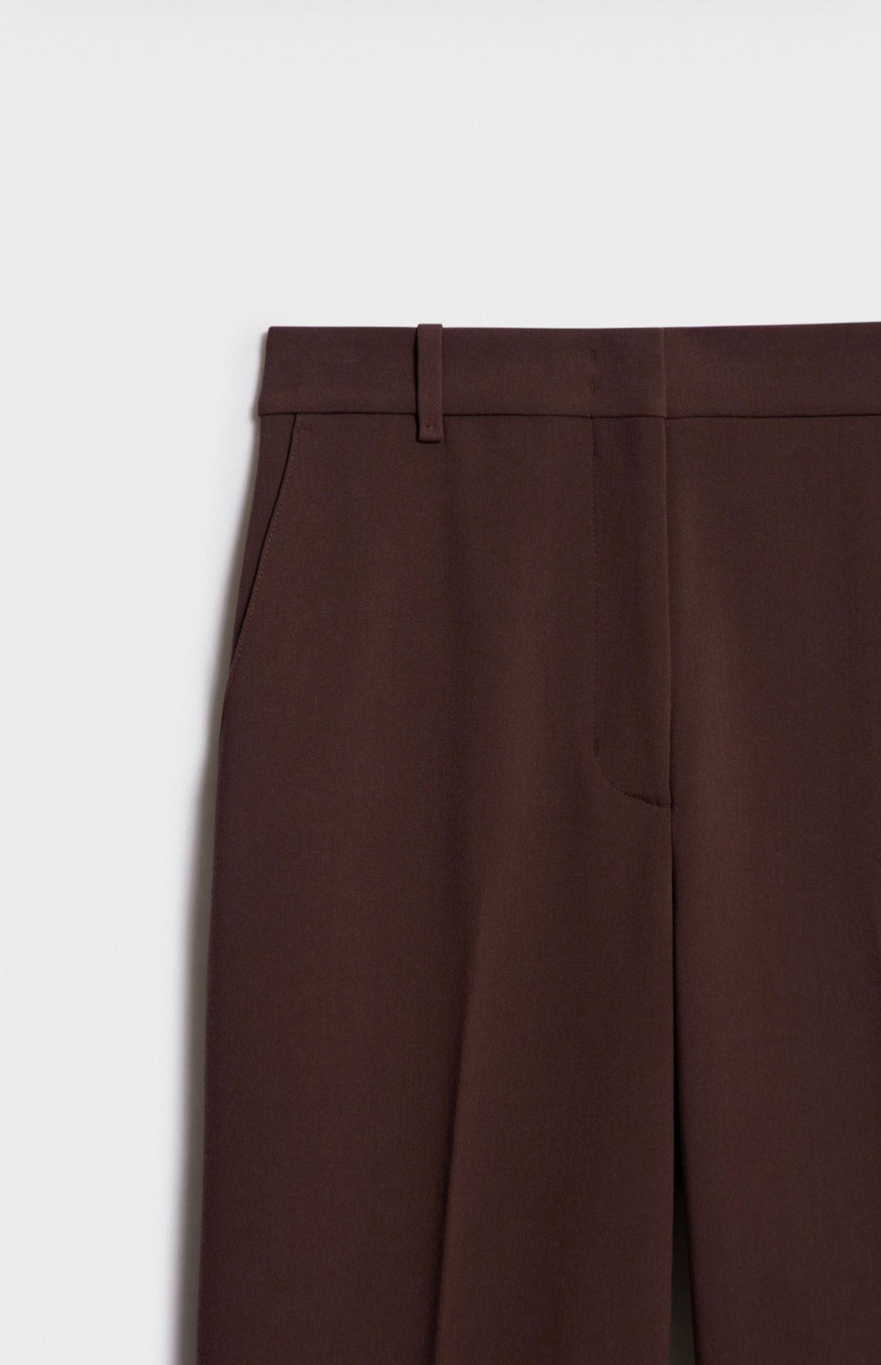 Detail shot of dark brown tailored trousers fabric and stitching Kochila Couture